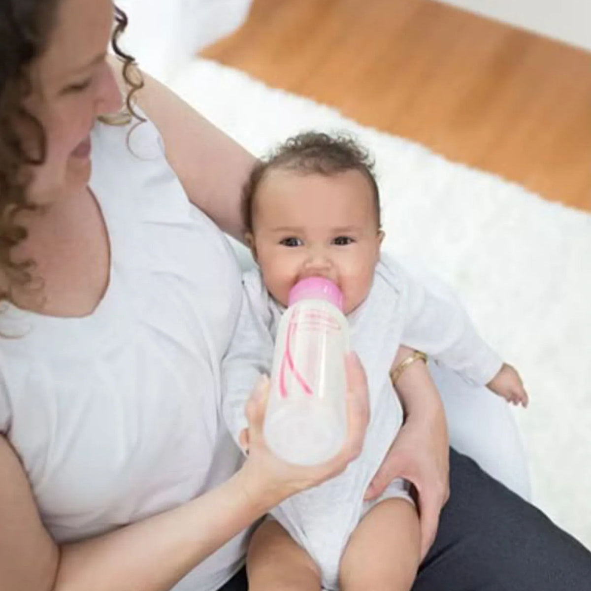 Baby being bottle fed with Dr. Brown's Options+ Pink Anti-Colic Baby Bottle 120ml