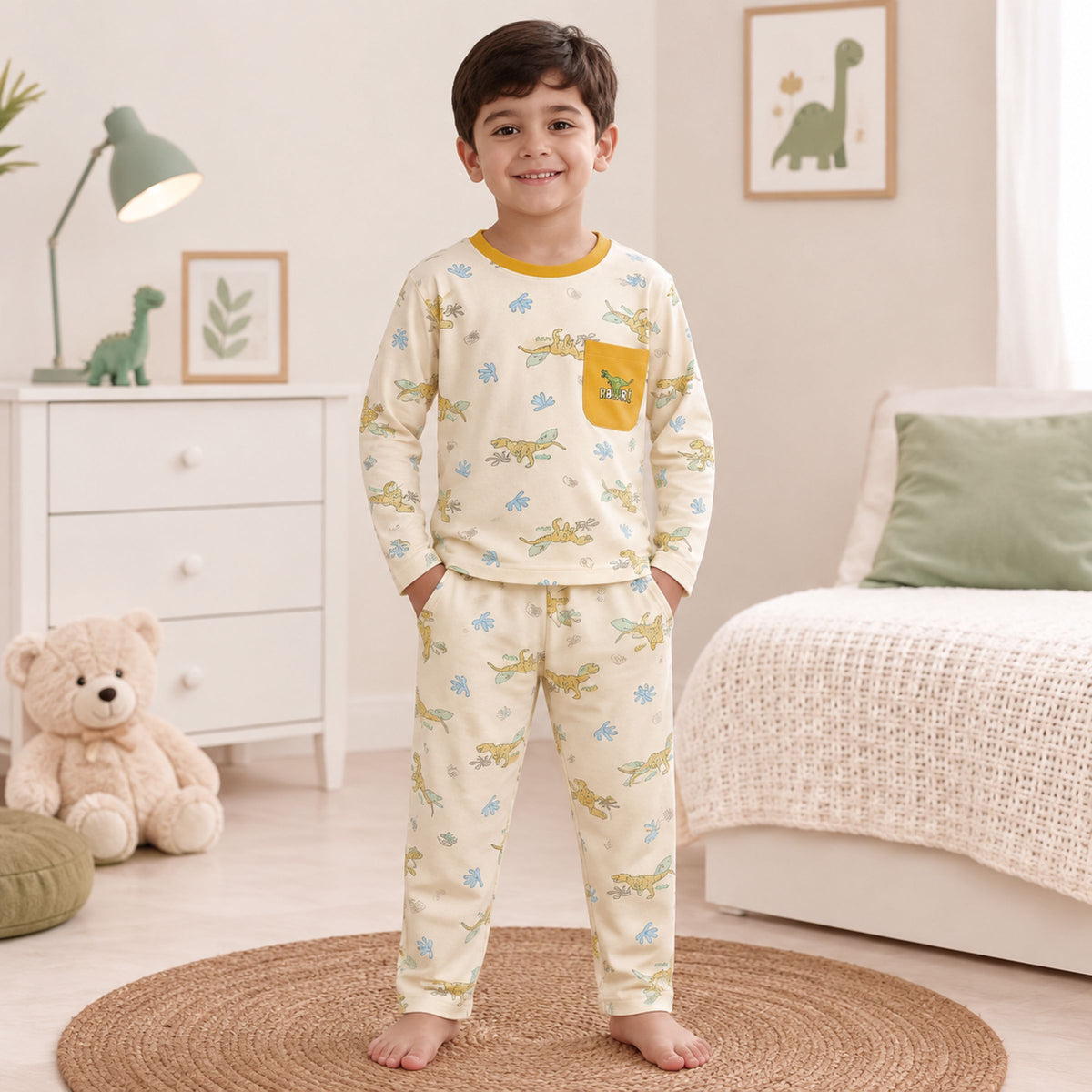 Smile Baby boys yellow premium cotton dinosaur print night suit with RAWR pocket worn by a child in a cozy bedroom