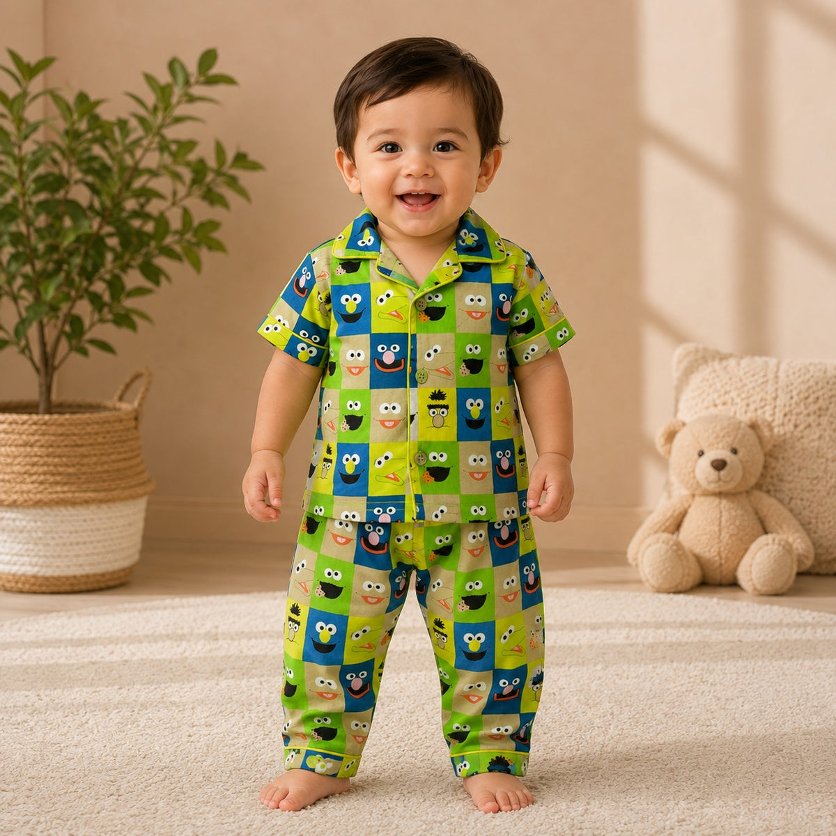 Boy wearing Smile Baby green cotton night suit with colorful cartoon check print front view