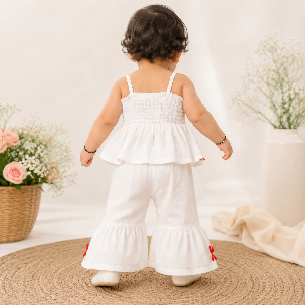 ROXY girls off white floral co-ord set back view showing gathered back top and matching flared palazzo pants