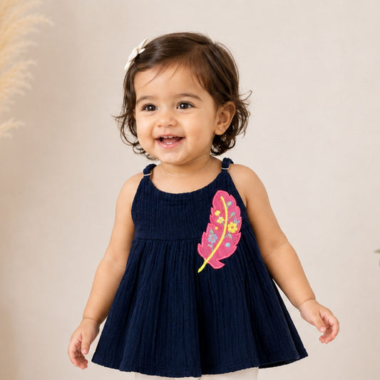 REVERSE X-TREME girls dark blue feather embroidered top front view with pink floral feather design and flared silhouette