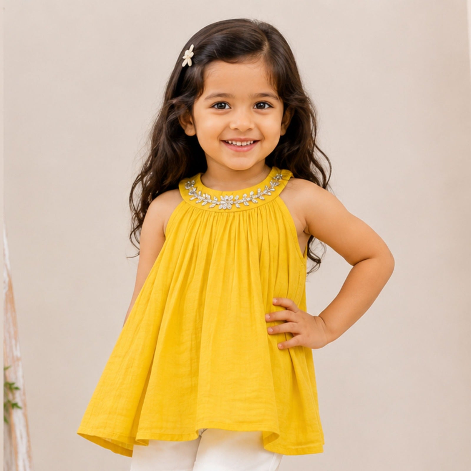 Girl wearing Reverse X-Treme Yellow floral embellished A-line sleeveless top with white shorts