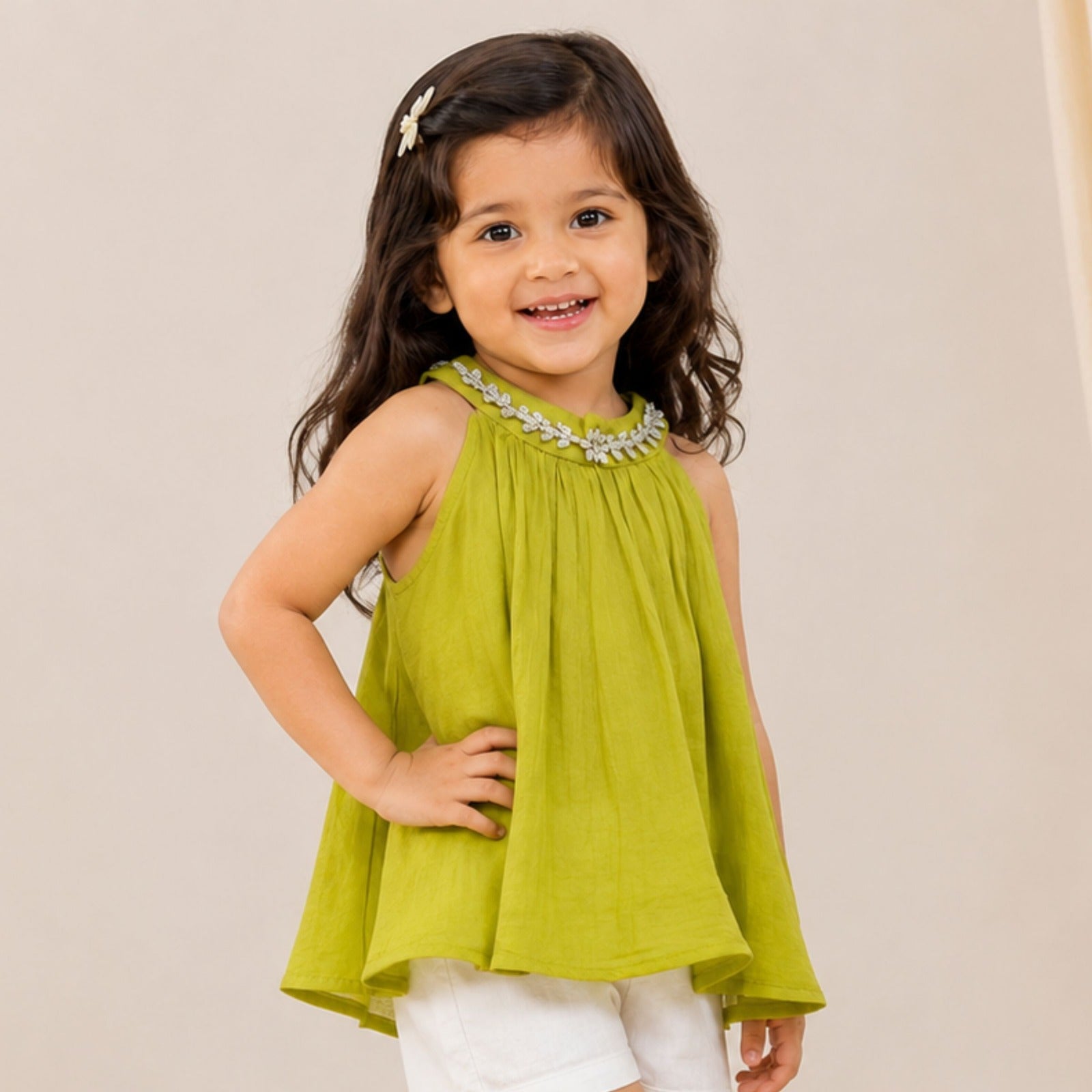 Girl wearing Reverse X-Treme N.Green floral embellished A-line sleeveless top with white shorts
