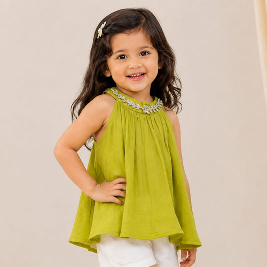 Girl wearing Reverse X-Treme N.Green floral embellished A-line sleeveless top with white shorts