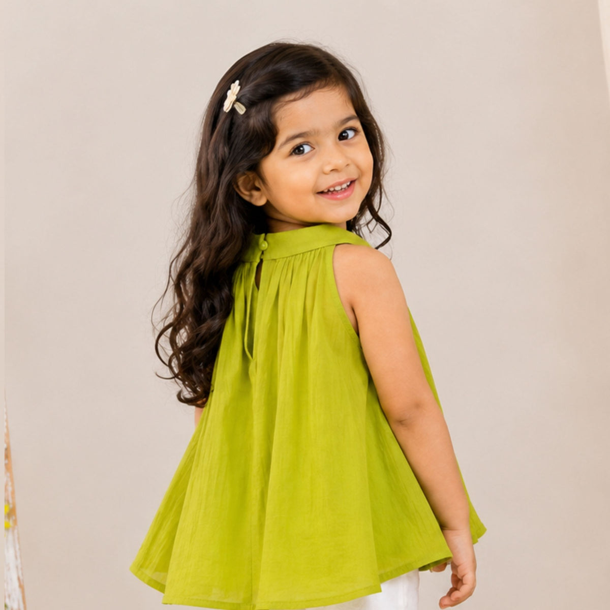 Back view of girl wearing Reverse X-Treme N.Green flared A-line sleeveless top with back button detail