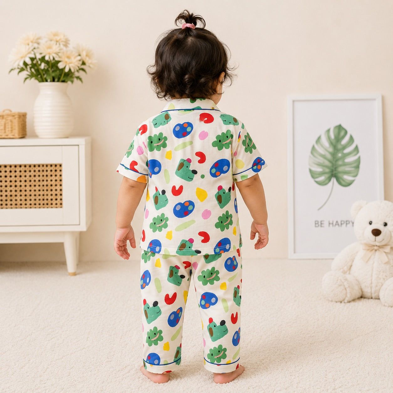 Back view of boy wearing Smile Baby cream cotton night suit with colorful playful animal print