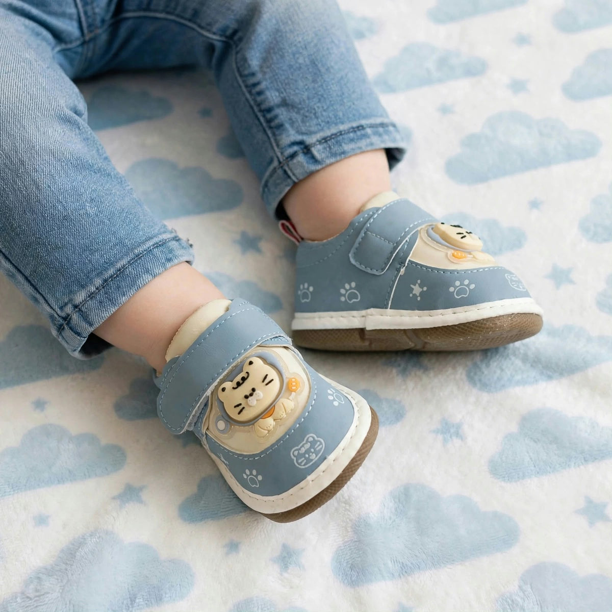 Smile Baby blue baby squeaker shoes worn by child with cute 3D cat design