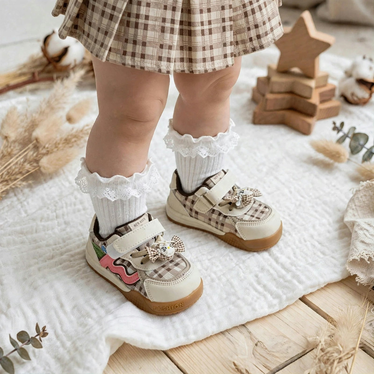 Smile Baby beige girls shoes worn by toddler with socks