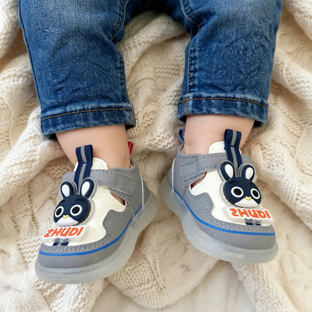 Smile Baby boys grey bunny LED shoes worn on feet with Velcro strap
