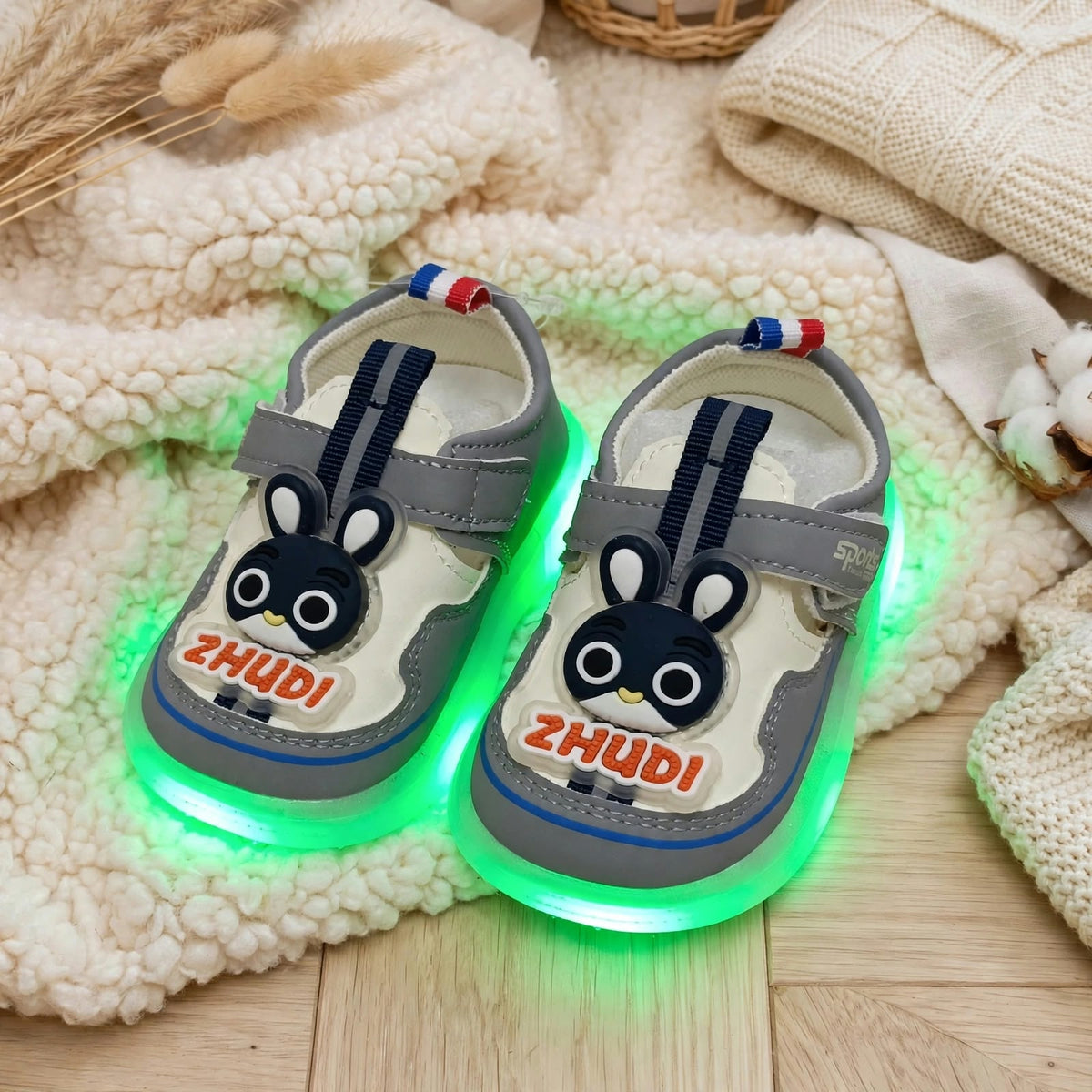 Smile Baby grey LED light-up shoes glowing green with bunny design