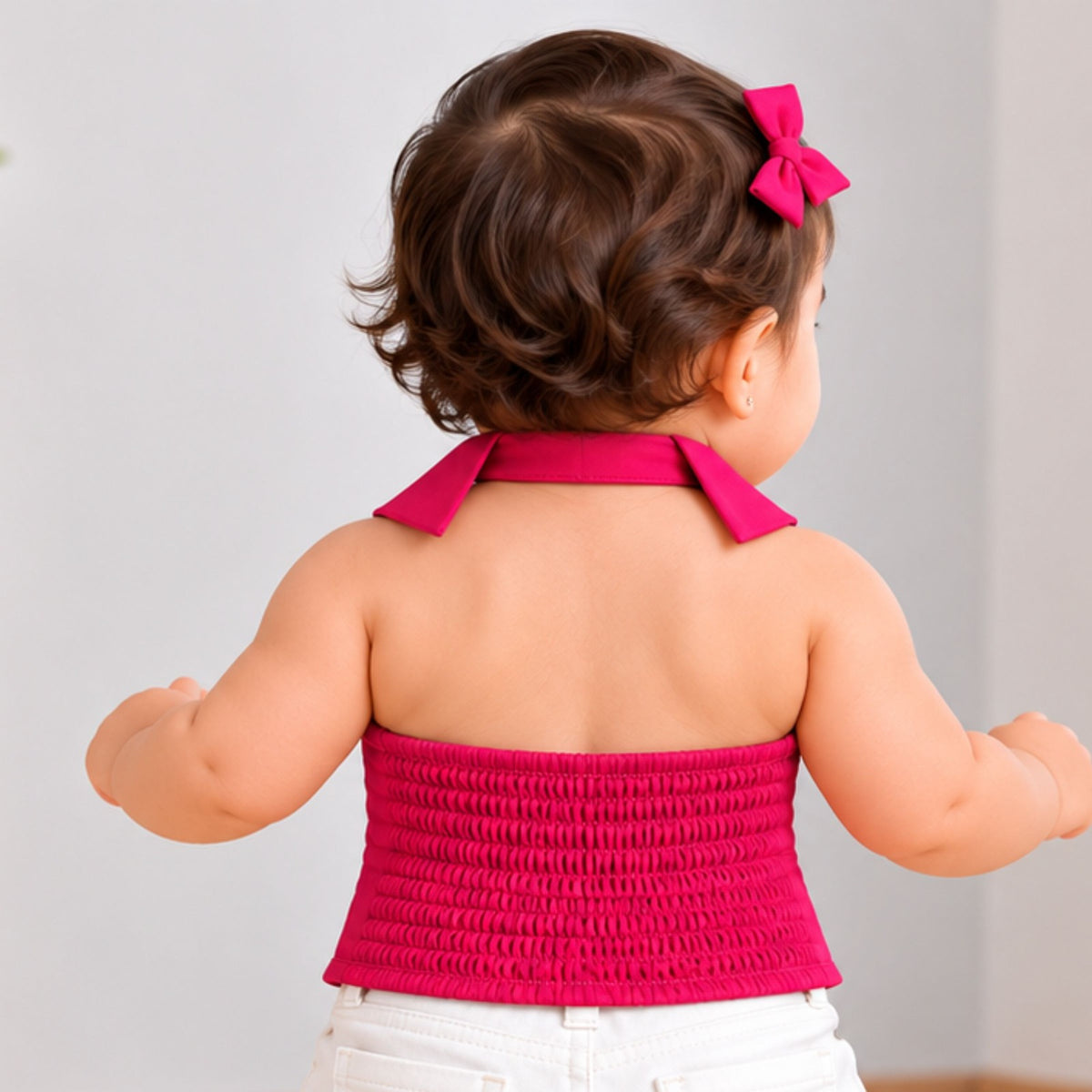 Back view of REVERSE X-TREME hot pink girls top showing smocked panel