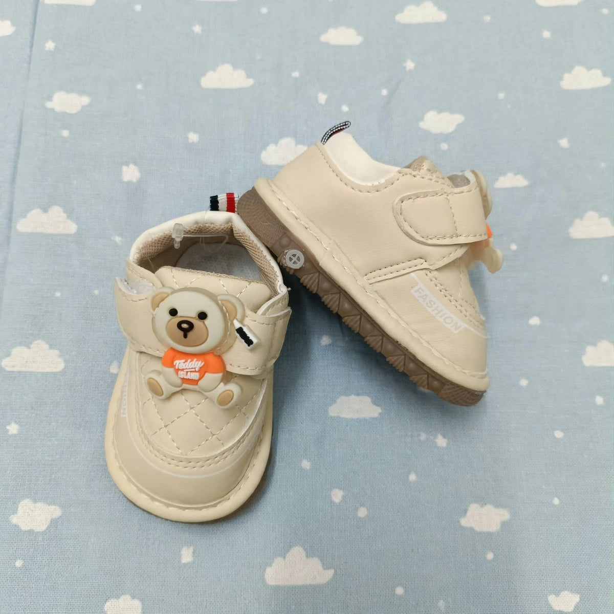 Smile Baby teddy bear first walker shoes worn by a baby